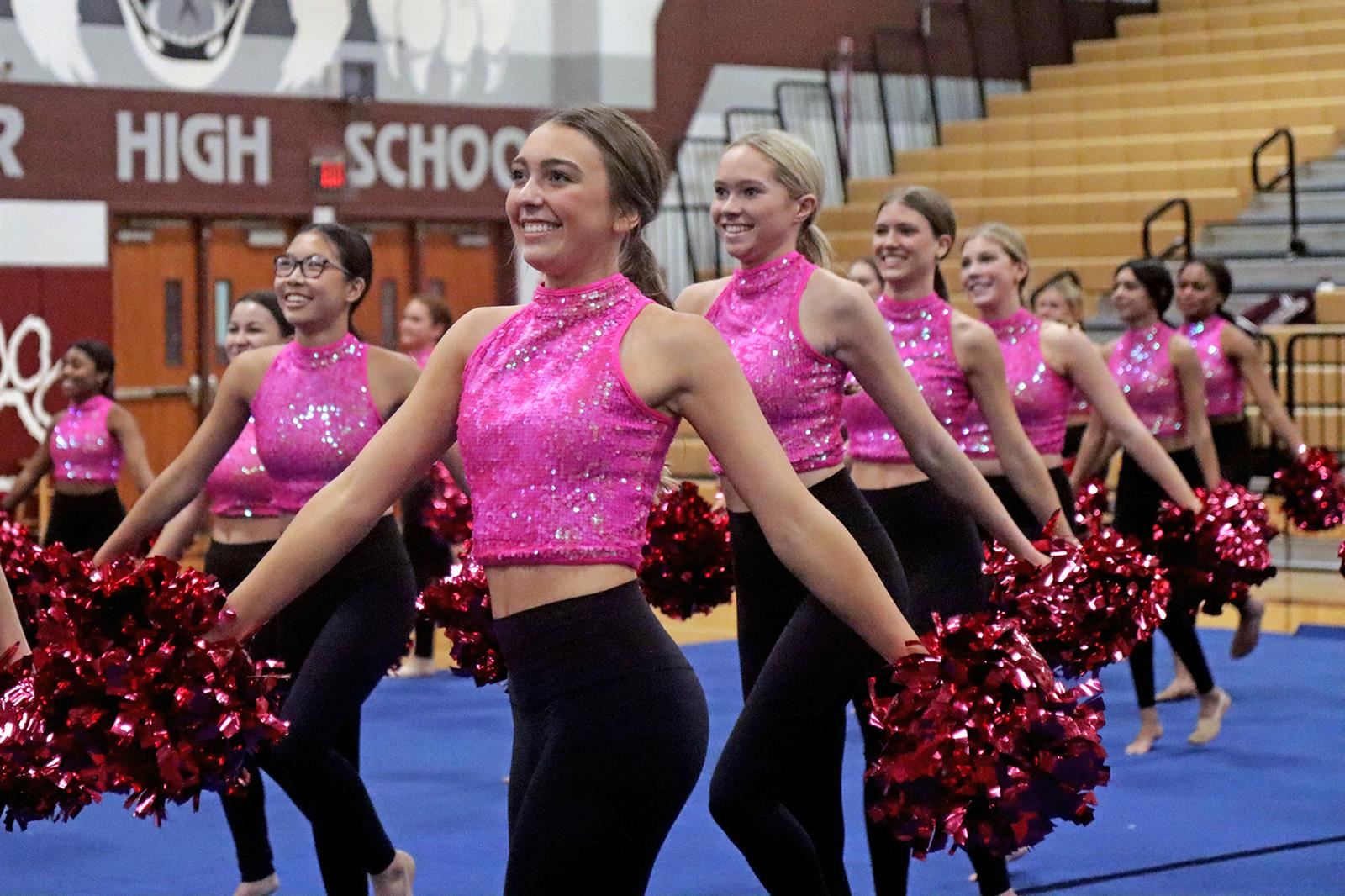 Cy-Fair Brigade members perform during the school’s Pink Out Rally. The drill team was joined by band, cheer and step team.